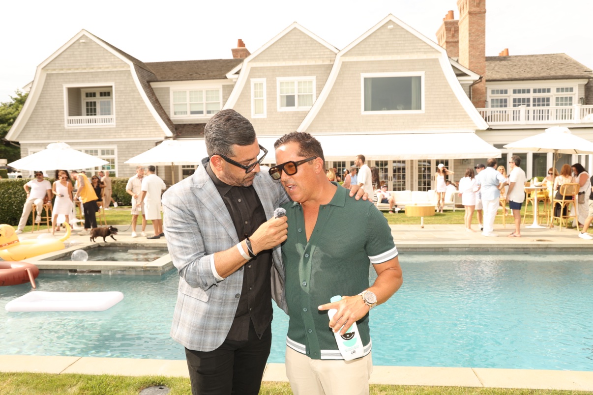 Richie Hosein with Josh Fox, founder of the Brady Hunter Foundation, poolside at a Hamptons estate