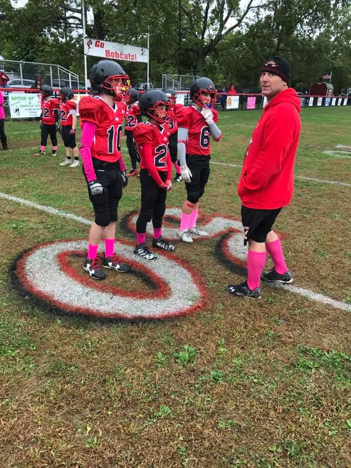 Richie Hosein coaching youth football players on game day in 2016