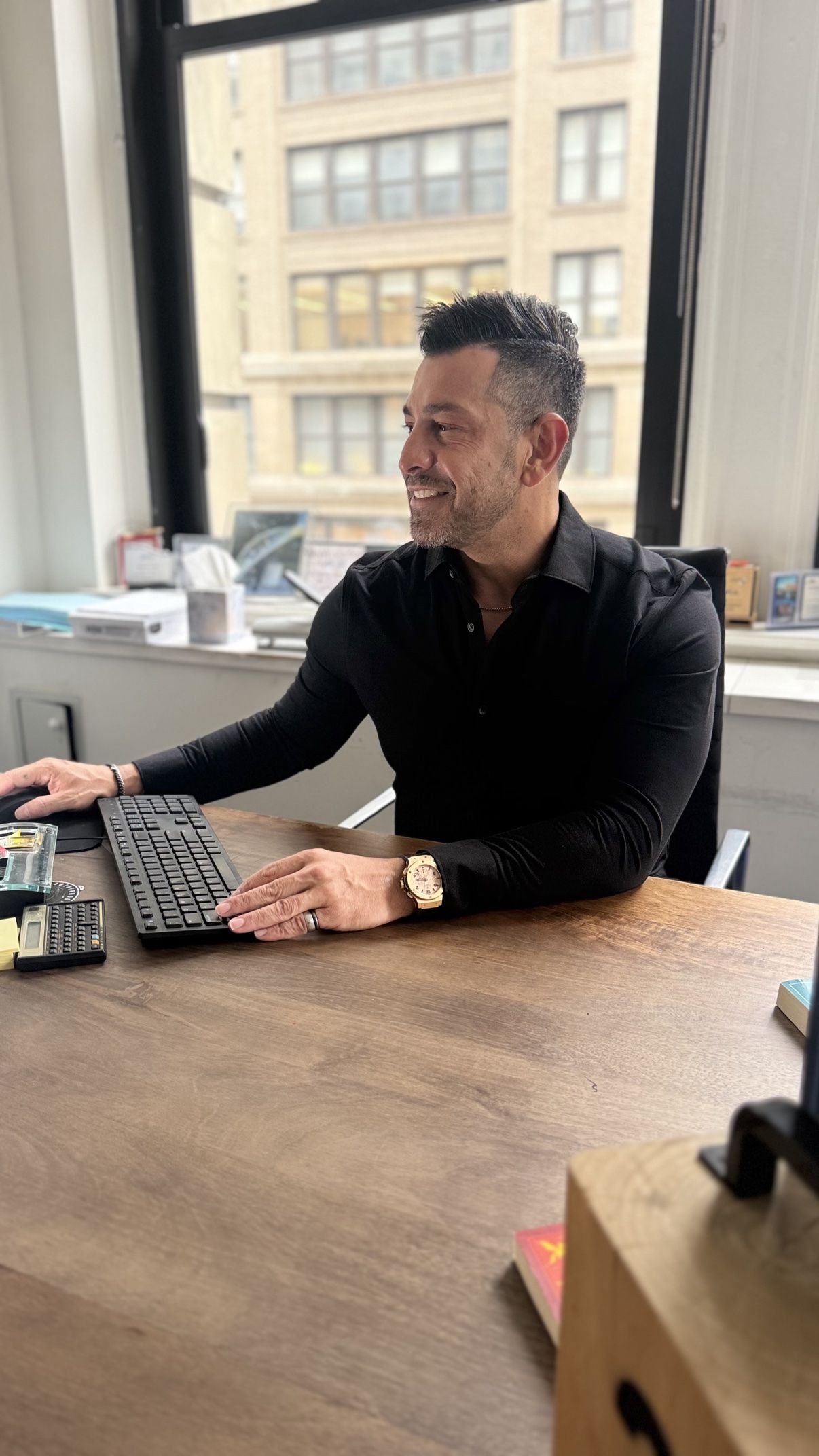 Richie Hosein working at his office desk
